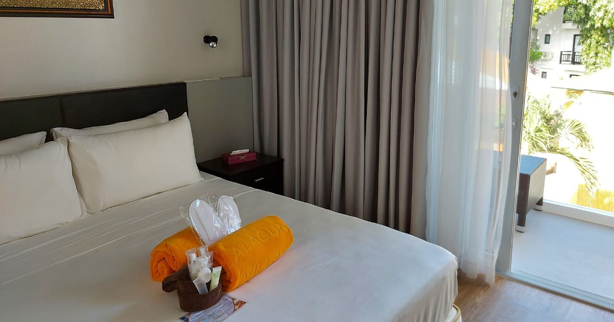 Spacious villa bedroom with ocean view balcony