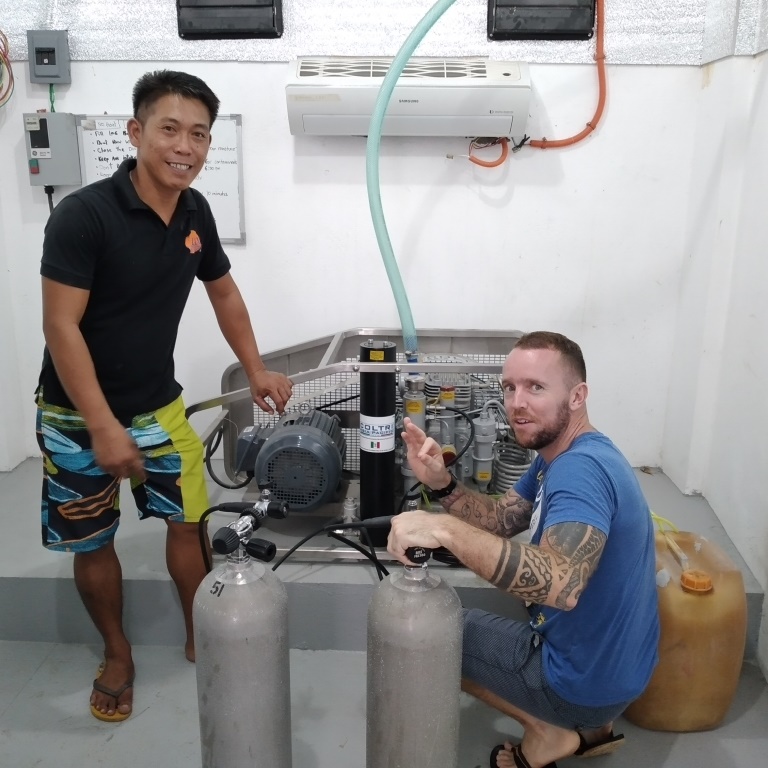 Dive shop manager Conan, and LLV Divers team member Diony, preparing to hit the water running when diving commences.