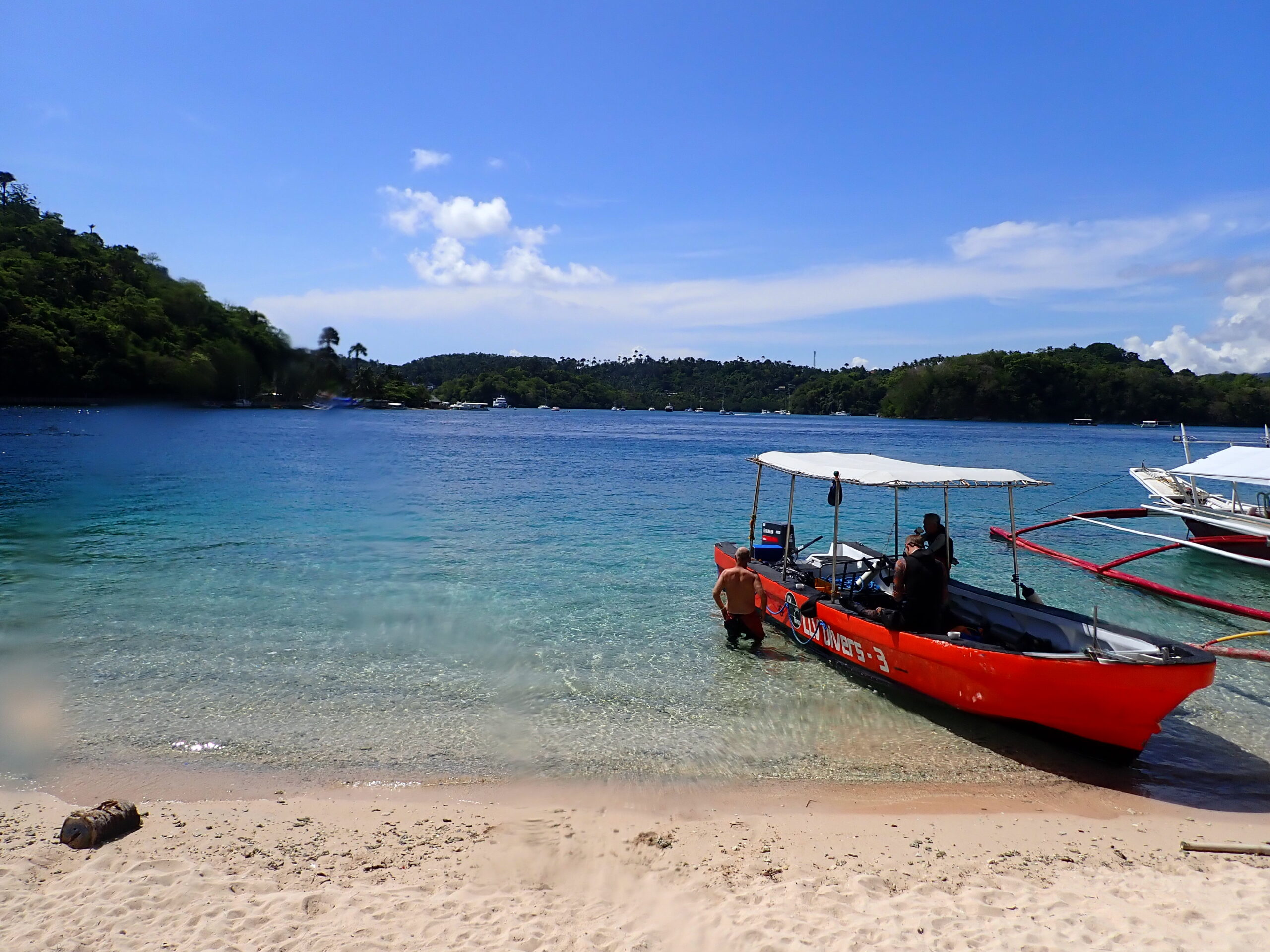 One of the LLV speedboats pausing on the shores of San Antonio island between a trip to Giant Clams and a visit to Montani