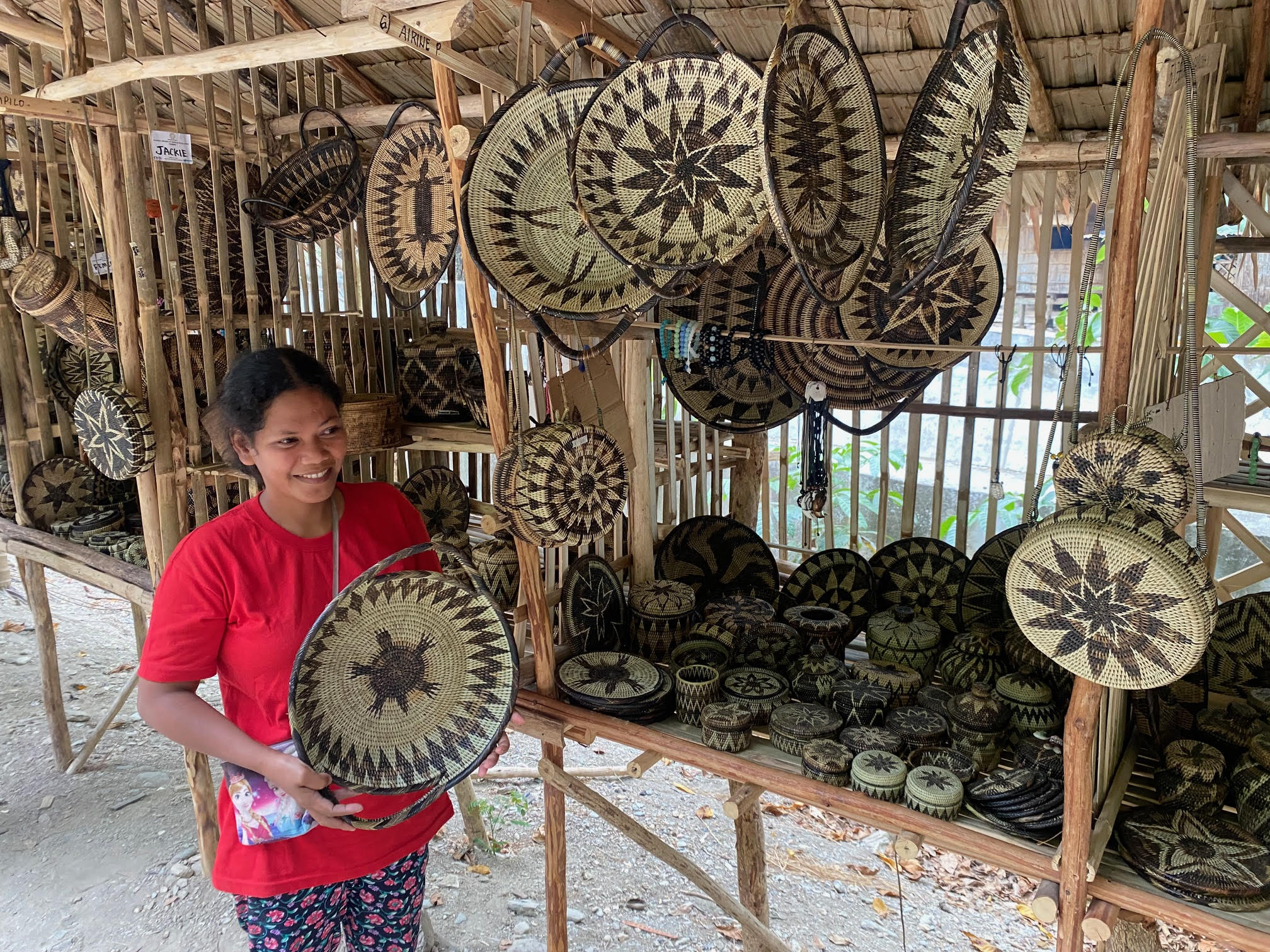 One of the talented basket weavers at the Iraya Mangyan Village displaying her wares